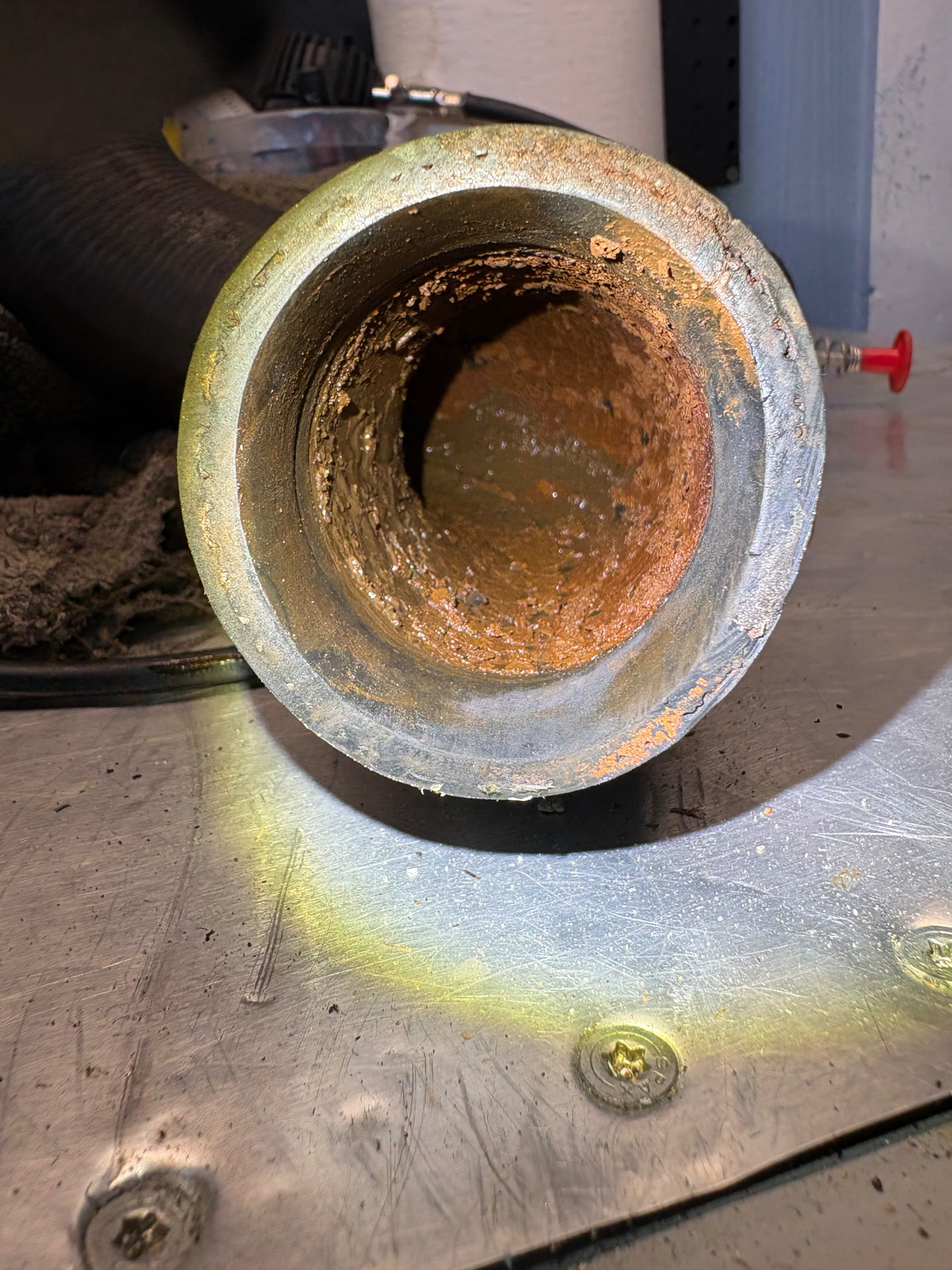 Heavily corroded and clogged metal pipe found during an inspection